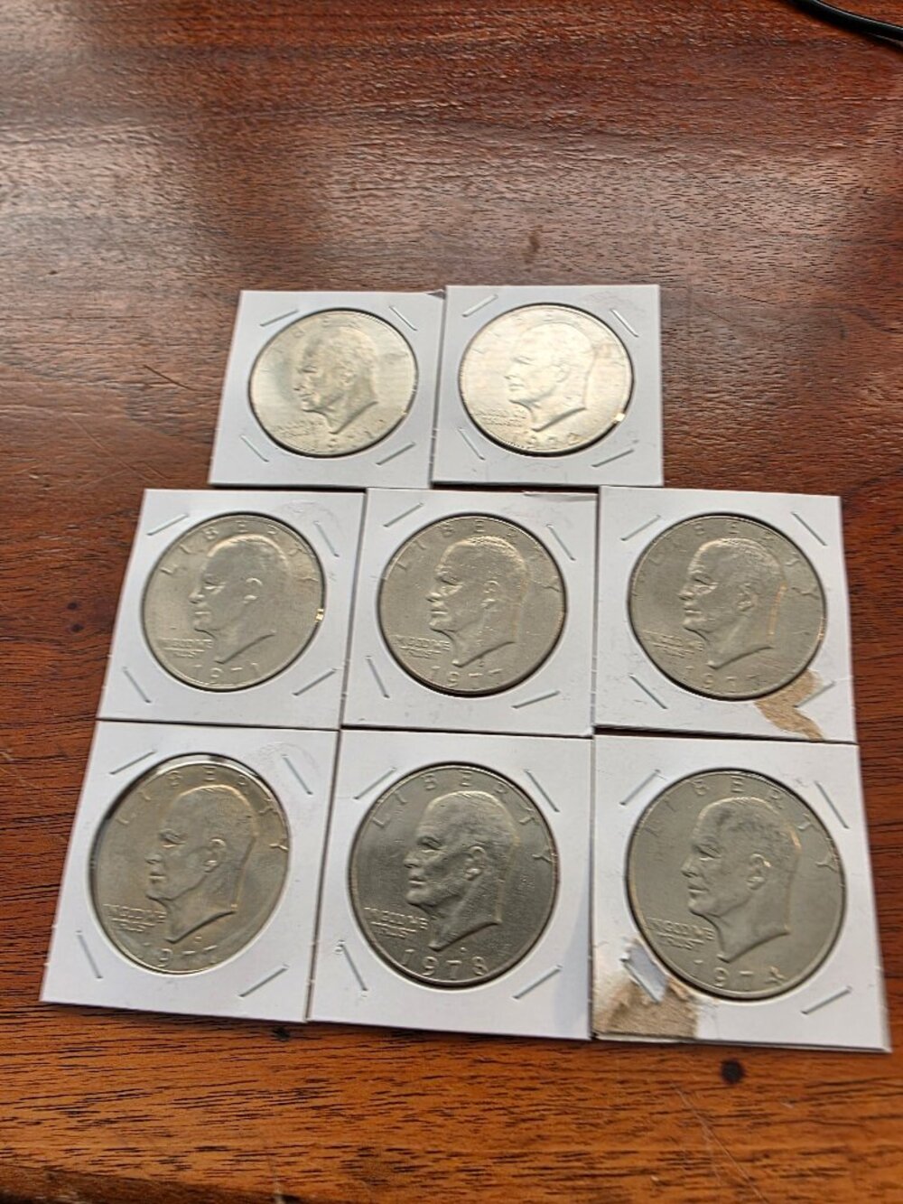 8PC LOT OF VARIOUS DATES OF EISENHOWER DOLLAR COINS.